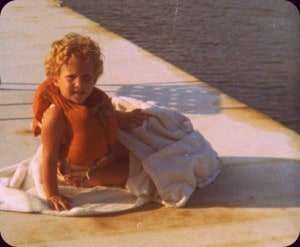 Sallie in life jacket & towel on dock