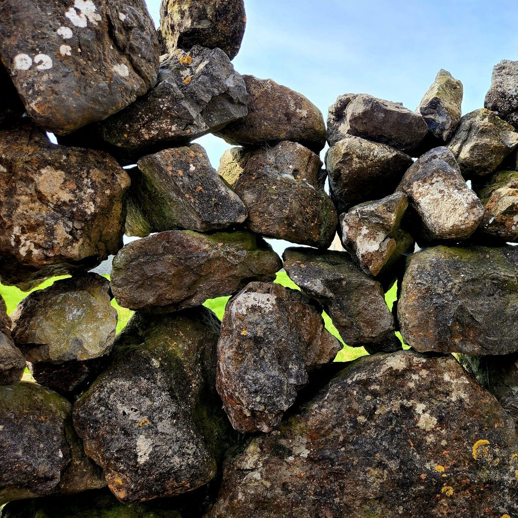 Close up of a stone wall. There is nothing used for mortar in these stone walls and fences. Tension is all that holds the stones in place. It's like magic! And they go on for miles and miles. 