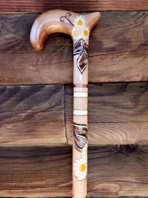 Learning to use a cane will be enhanced by this hand carved cane from Ukrane stained in a pale brown with three white chamomile flowers, brown leaves and some white stripes carved into the cane.